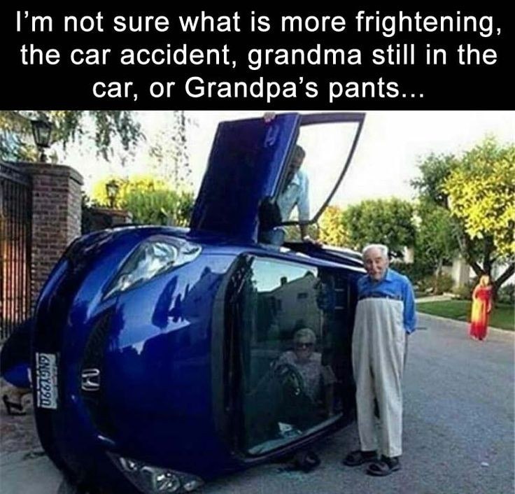 a man standing next to a car with the hood open
